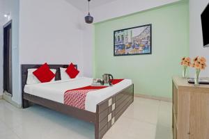 une chambre avec un lit avec des oreillers rouges dans l'établissement Hotel O Beautiful Stay Homes, à Hyderabad