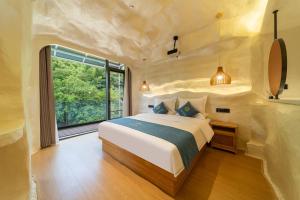 a bedroom with a large bed and a large window at Floral Luxury Xijiantang B&B in Jingxian +105 photos