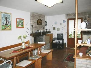 a living room with a table and a fireplace at Farmhouse in Fano with Pool & Adriatic Views in Montemaggiore al Metauro
