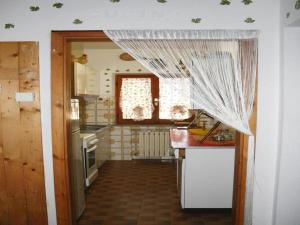 a kitchen with a curtain hanging over a kitchen counter at Farmhouse in Fano with Pool & Adriatic Views in Montemaggiore al Metauro