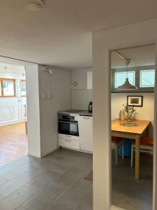 a kitchen with a table and a stove top oven at Villa Room in Malmö