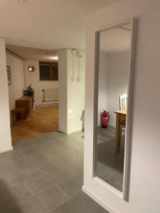 a mirror on the wall of a living room at Villa Room in Malmö