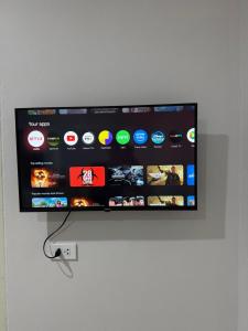 a flat screen tv hanging on a wall at GlassHouse in Udon Thani