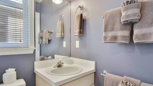 a bathroom with a sink and a mirror at A Little Slice Of Paradise by AvantStay Communal Pool Screened in Porch Great Location Month Long Stays in Stock Island +16 photos