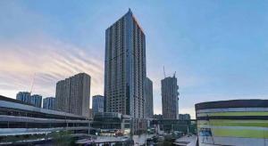 a group of tall buildings in a city at Xana Hotelle· Wulumuqi High Speed Railway Station Baonengcheng in Ürümqi