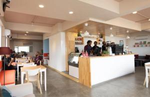 a group of people sitting at a counter in a restaurant at Nala Host- Sea Breeze 1BR apartment in Hulhumale