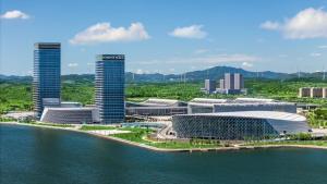 an aerial view of a city next to the water at Crowne Plaza Weihai Binhai by IHG in Weihai