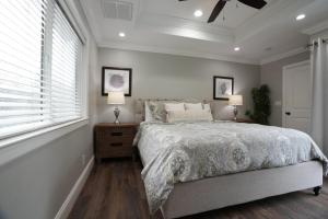 a bedroom with a bed and two lamps and a window at Destination #39 in Orange +41 photos