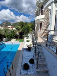 a swimming pool with stairs next to a house at Budva City - Villa Antic - Private Pool in Budva