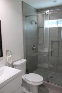 a bathroom with a toilet and a glass shower at Newly Renovated La Habra 3bed 2 Bath in La Habra