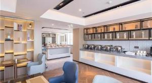 a large room with a store with blue chairs and tables at Echarm Hotel Changsha Xiangya Fushan in Changsha +116 photos