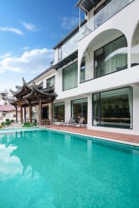 a swimming pool in front of a building at Floral Luxury Xijiantang B&B in Jingxian