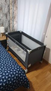 a black bed frame in a room with a bed at CASA RAMI especial parejas in San Martín del Rey Aurelio