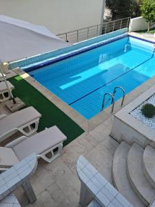 a swimming pool with two chairs and a table at Budva City - Villa Antic - Private Pool in Budva