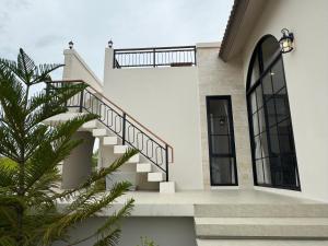 a stairway in a house with a palm tree at The Lush Valley Khao yai in Ban Bung Toei