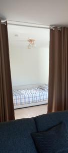 a bed in a room with curtains and a mattress at Apartment for 5 people, 2 rooms, kitchen, bathroom, balcony in Germersheim +6 photos