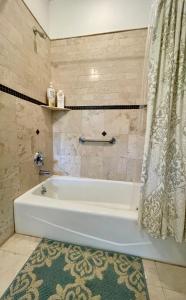 a white bath tub in a bathroom with a shower curtain at Spacious Guest Suite 5 Minutes to Princeton University with Free Parking in Princeton