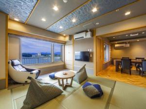a living room with a couch and a table at Yanagiya in Shirahama