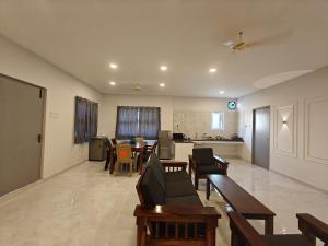 a living room with a couch and a table at HOTEL SAlBALA INN & HOMESTAY - NEAR AIRPORT in Chennai
