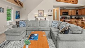 a living room with a couch and a table at Alpine Serenity by AvantStay Beach Lake Access Theater Deck Playroom in Albrightsville