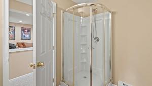 a shower with a glass door in a bathroom at Alpine Serenity by AvantStay Beach Lake Access Theater Deck Playroom in Albrightsville +47 photos