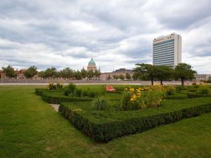 a garden with bushes and flowers in a park at Mercure Hotel Potsdam City in Potsdam