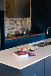 a kitchen counter with a plate of eggs and a book at Whistlewood - Stunning Views in the Adelaide Hills in Upper Sturt