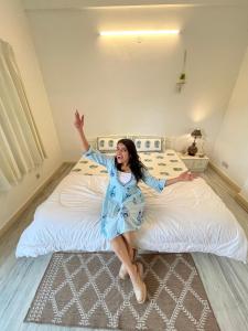 a woman is laying on a bed at Gulab Niwas Homestay in Udaipur