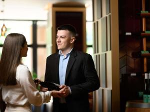 a man and a woman standing next to each other at Mercure Budapest Korona in Budapest