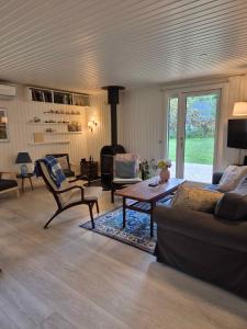 a living room with a couch and a coffee table at Unobstructed Summer House In Lovely Langeland in Tranekær