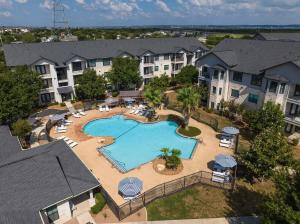 an aerial view of an apartment complex with a swimming pool at Landing Spectacular 1BD Pool Gym in San Antonio