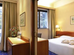 Ένα ή περισσότερα κρεβάτια σε δωμάτιο στο Mercure Reggio Emilia Centro Astoria +77 φωτογραφίες