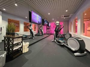 a gym with two women on tread machines and a tv at Ahern Hotel and Event Center in Las Vegas