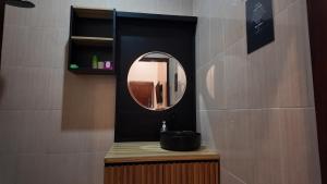 a bathroom with a sink and a mirror on a counter at Light Star Kuta Lombok in Kuta Lombok +17 photos
