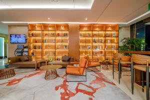 a lobby with couches and tables in a room at Echarm Plus Hotel Nanning Convention and Exhibition Center Medical University in Nanning