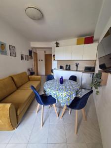 a living room with a table and chairs and a couch at Due Sorelle in Santa Teresa di Riva
