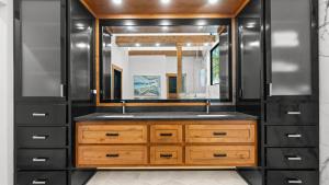 a bathroom with a sink and a large mirror at The Grand on Greenbay-7 bedrooms Sleeps 20 Modern new build in Mooresville +45 photos