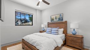 a bedroom with a bed and two lamps and a window at The Grand on Greenbay-7 bedrooms Sleeps 20 Modern new build in Mooresville