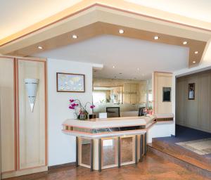 a large kitchen with a counter in a room at Hotel Villa Sulmana in Neckarsulm