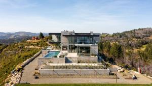 a house on a hill with a swimming pool at Belleza by AvantStay Hilltop Mansion w Pool Panoramic Views Ultra Modern Interior in Glen Ellen