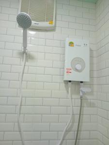 a shower in a bathroom with a blow dryer at KOOK BUNGALOW in Koh Mook
