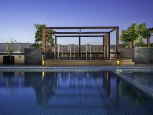 a swimming pool with a gazebo and a swimming pool at Pullman Dubai Creek City Centre in Dubai