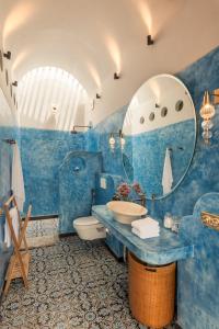 a blue bathroom with a sink and a mirror at La Dona by The Blue Kite - 4BHK Private Pool Villa in Assagao with Garden, Balcony, Caretaker & Spacious Living Area in Assagao