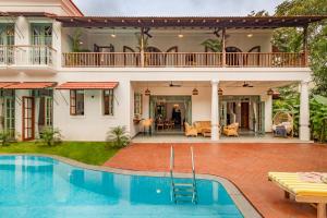 a villa with a swimming pool and a house at La Dona by The Blue Kite - 4BHK Private Pool Villa in Assagao with Garden, Balcony, Caretaker & Spacious Living Area in Assagao +34 photos