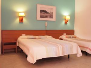 Postel nebo postele na pokoji v ubytování Hotel El Castell