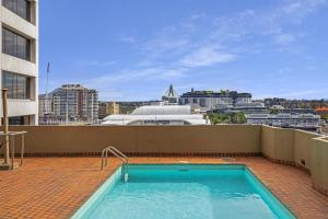 a swimming pool on the roof of a building at Metro Apartments on King in Sydney