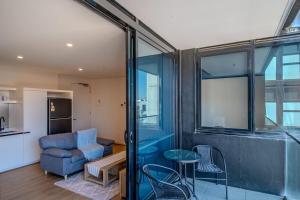 a living room with a couch and a chair at Cosy 1 Bedroom Studio Hawthorn near Swinburne Uni in Melbourne
