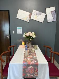 ein Tisch mit einer Vase mit Blumen darauf in der Unterkunft 90 Sqm Perfect Seaview Luxurious Modern 2 Bedrooms, Nearby Okada, Solaire, Airports, MOA with Free Parking in Manila