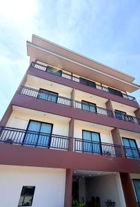 a building with balconies on the side of it at KT Hotel Airport in Nai Yang Beach