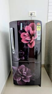 a refrigerator with purple flowers painted on it at Jalsa Home Stay in Sheoganj